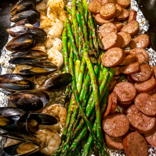 Shrimp sheet pan dinner with asparagus sausage and mussels